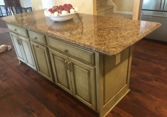 brown speckled granite counter and green and gold fleck cabinets