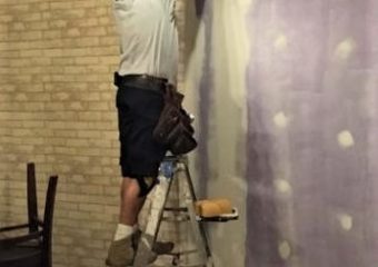 employee installing wallpaper