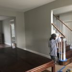 Painter refinishing a wooden staircase