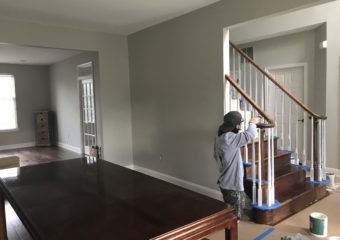 Painter refinishing a wooden staircase