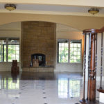 home entrance with marble floors, stairs and a stone fireplace