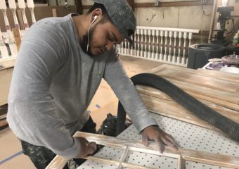 P&W Employee Refinishing a Window Pane